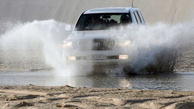Dune bashing, or taking a thrilling ride in a four-wheel-drive vehicle all over desert sand dunes, is a popular excursion in Qatar. // © 2015 Gulf Adventures
