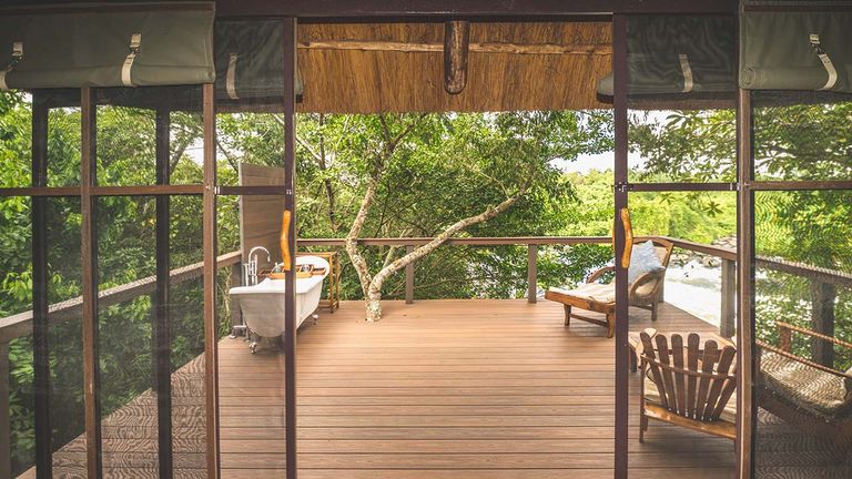 Guests can take a bath on their secluded wooden porch.