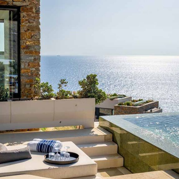 Villas at One&Only Kea Island feature private infinity pools and a sunken lounge area.