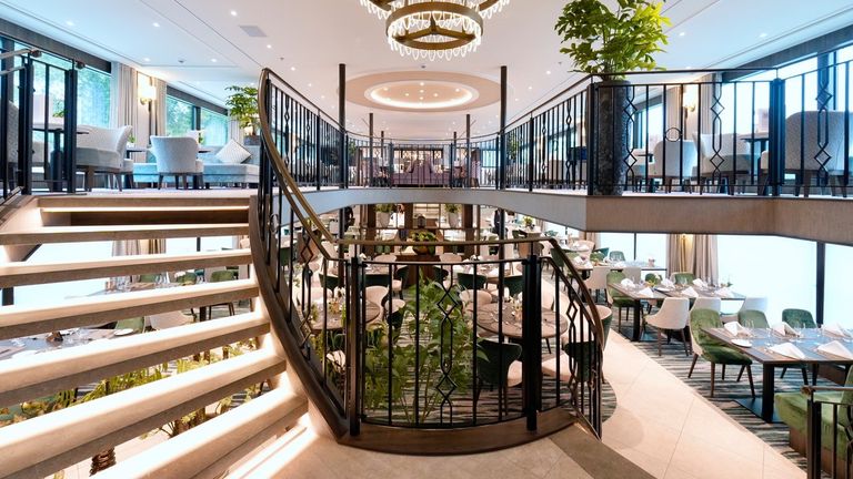 Riviera Radiance’s design aesthetic features wrought-iron railings and chandeliers.